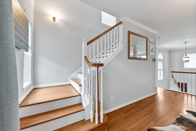 1708 Wilson St, Houston, TX 77019 - staircase with wood finished floors, crown molding, and baseboards