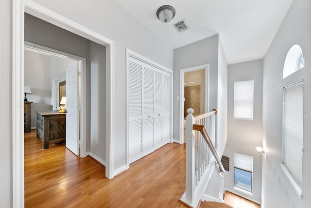 1708 Wilson St, Houston, TX 77019 - corridor with an upstairs landing, light wood finished floors, and baseboards