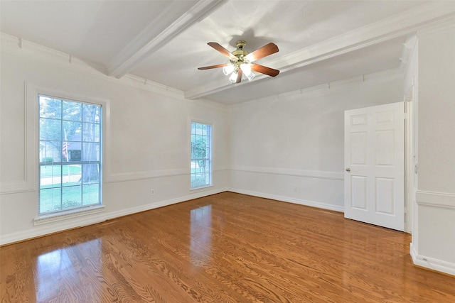 unfurnished room with beam ceiling, a ceiling fan, wood finished floors, baseboards, and crown molding