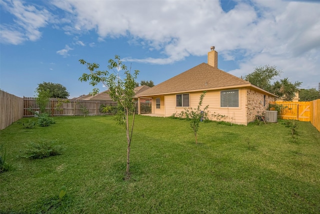 rear view of property featuring a chimney and cooling unit