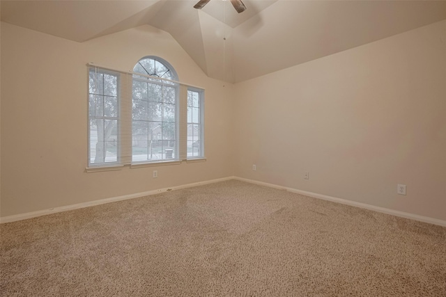 spare room featuring ceiling fan, carpet flooring, vaulted ceiling, and baseboards