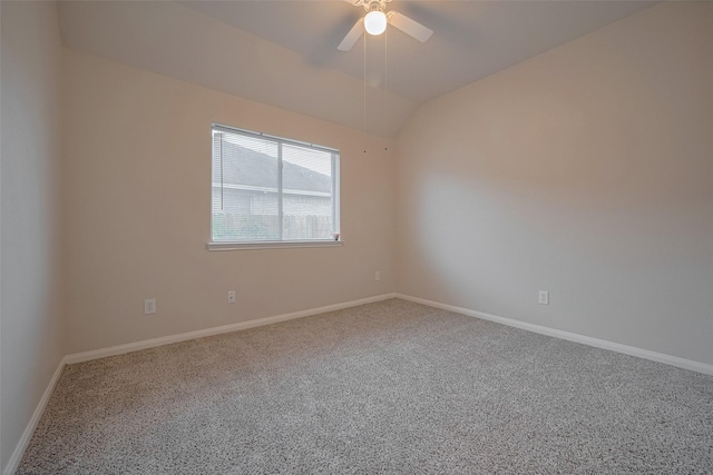 carpeted empty room featuring ceiling fan, baseboards, and vaulted ceiling