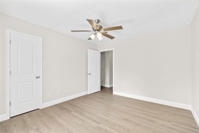 unfurnished bedroom featuring light wood-type flooring, baseboards, and a ceiling fan