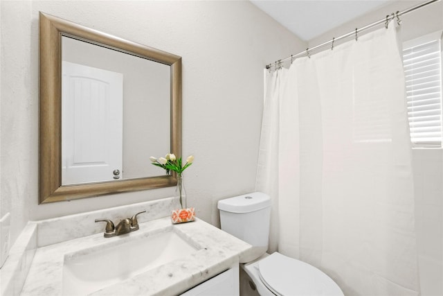 full bath featuring vanity and toilet