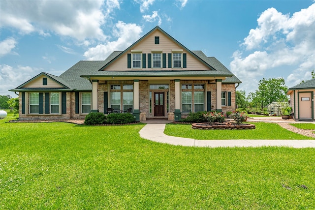 11413 7th St, Santa Fe, TX 77510 - craftsman-style house with a front yard, brick siding, and covered porch