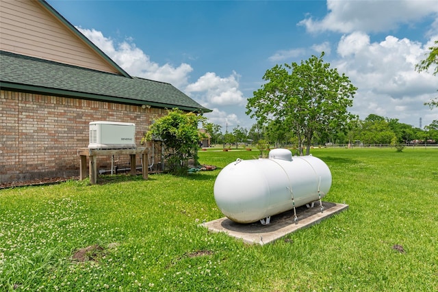 11413 7th St, Santa Fe, TX 77510 - exterior view of gas tank, brick siding, and roof with shingles