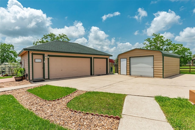 11413 7th St, Santa Fe, TX 77510 - view of front of house featuring a garage, an outbuilding, fence, and a shingled roof