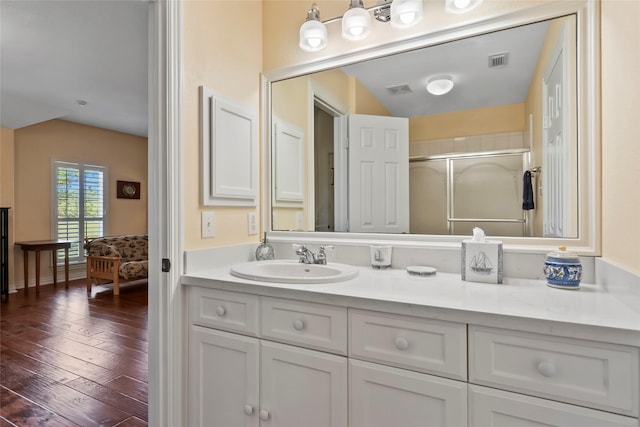 11413 7th St, Santa Fe, TX 77510 - bathroom with a stall shower, vanity, and hardwood / wood-style floors