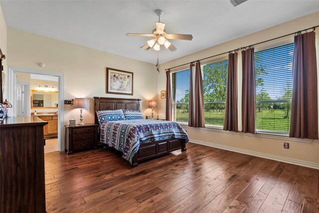 11413 7th St, Santa Fe, TX 77510 - bedroom featuring baseboards, dark wood finished floors, ceiling fan, and connected bathroom