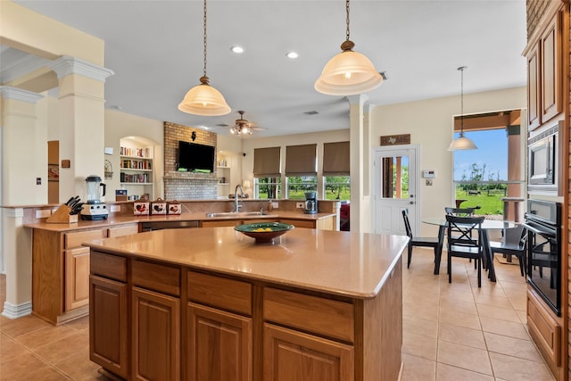 11413 7th St, Santa Fe, TX 77510 - kitchen with a center island, decorative columns, light tile patterned floors, appliances with stainless steel finishes, and ceiling fan
