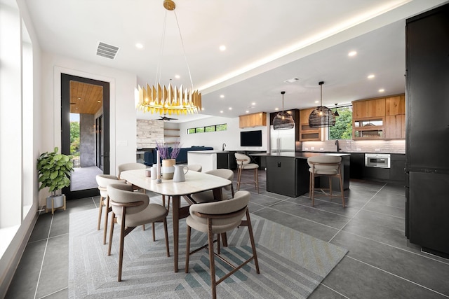 dining room featuring plenty of natural light, recessed lighting, and a chandelier