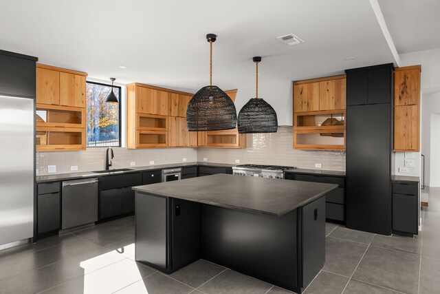 kitchen featuring open shelves, dishwasher, a sink, dark countertops, and backsplash