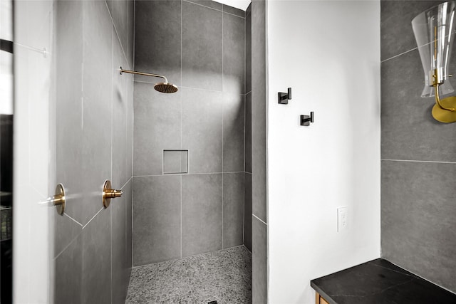 full bath with a tile shower