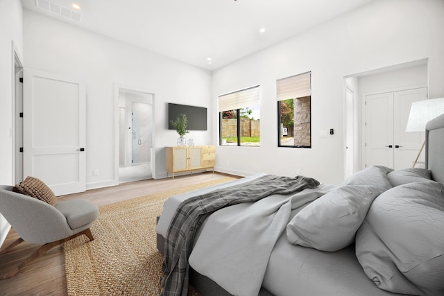 bedroom featuring wood finished floors, baseboards, and recessed lighting