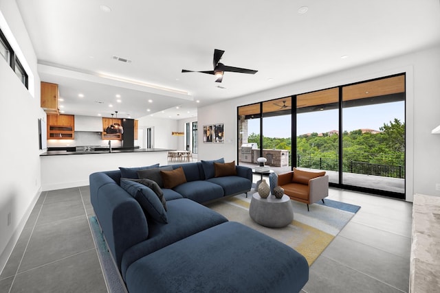 living room featuring recessed lighting, ceiling fan, and baseboards