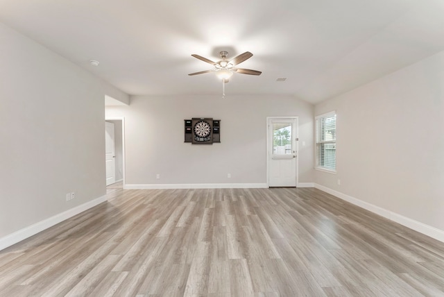 unfurnished living room featuring ceiling fan, light wood-style flooring, baseboards, and vaulted ceiling