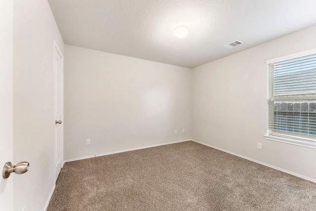 carpeted empty room with baseboards