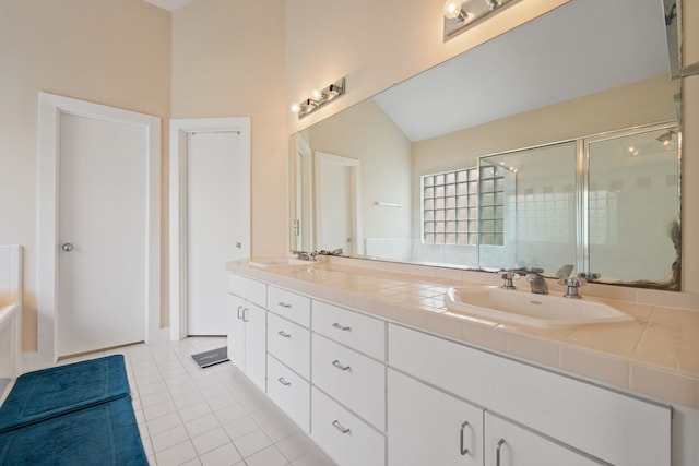 full bathroom featuring tile patterned flooring, a stall shower, double vanity, vaulted ceiling, and a bath