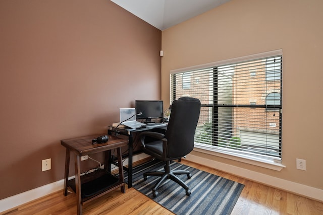 home office with wood finished floors and baseboards