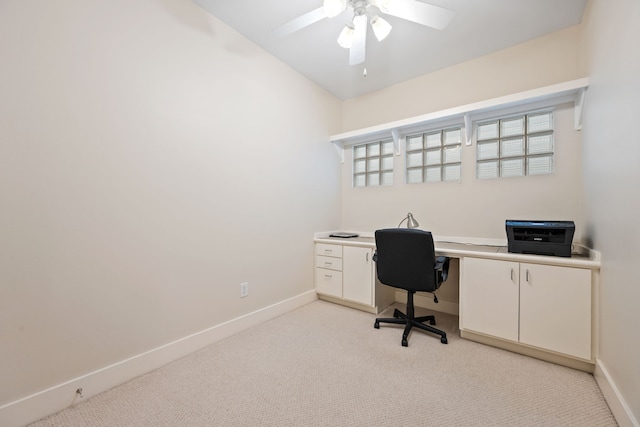 office area with light carpet, baseboards, and ceiling fan
