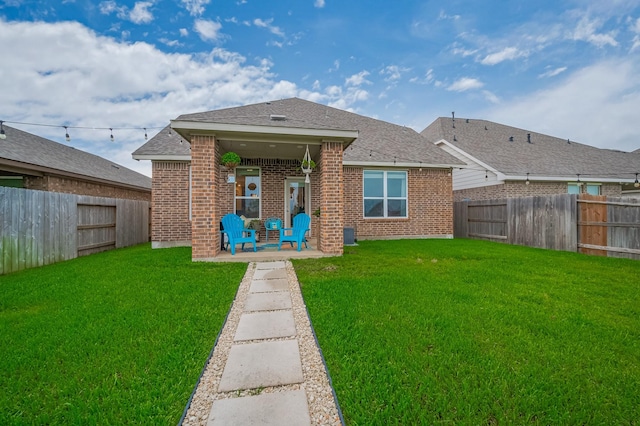4314 Reese Ravine Ln, Katy, TX 77493 - rear view of house with brick siding, a patio, and roof with shingles