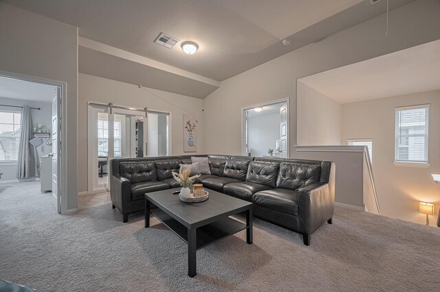 4314 Reese Ravine Ln, Katy, TX 77493 - living area with light colored carpet, plenty of natural light, a barn door, and attic access