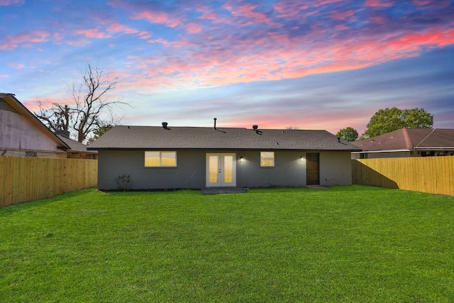 5506 Karelian Dr, Houston, TX 77091 - back of property at dusk featuring french doors, a shingled roof, and brick siding