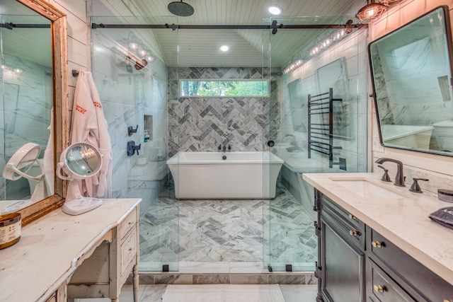 full bathroom with tile walls, marble finish flooring, a soaking tub, vanity, and a tile shower