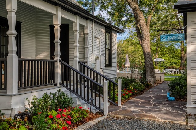 view of exterior entry with covered porch
