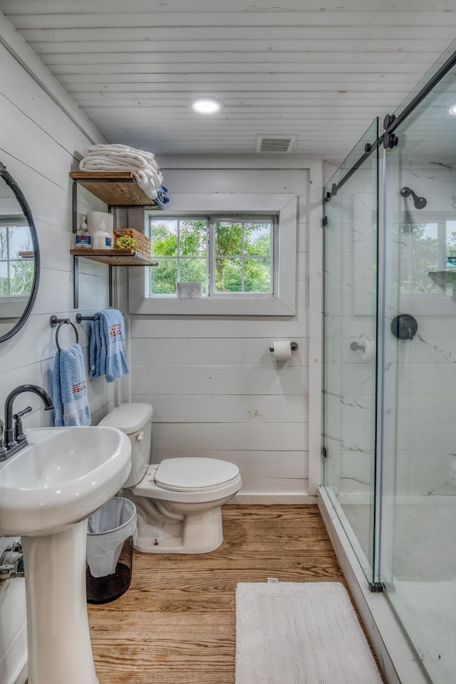 full bath with wood finished floors, toilet, a marble finish shower, wooden ceiling, and a sink