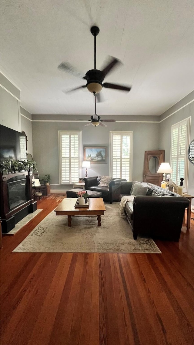 636 S Franklin, La Grange, TX 78945 - living area with wood finished floors, healthy amount of natural light, ceiling fan, and a fireplace with flush hearth