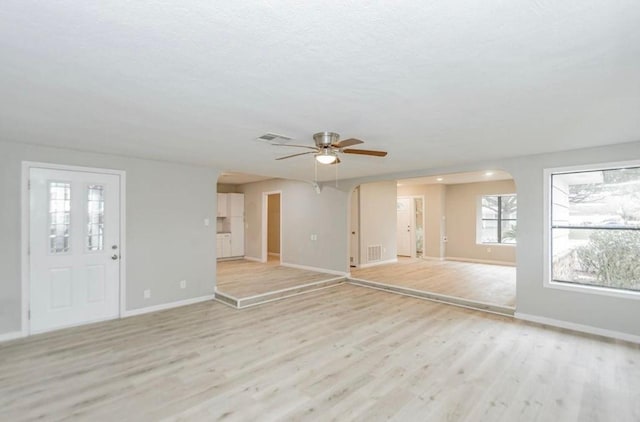 148 Seaside Ln, Texas City, TX 77590 - unfurnished living room with a ceiling fan, light wood-style floors, and baseboards