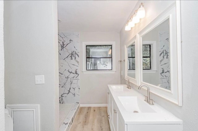 148 Seaside Ln, Texas City, TX 77590 - bathroom with a marble finish shower, wood finished floors, and double vanity