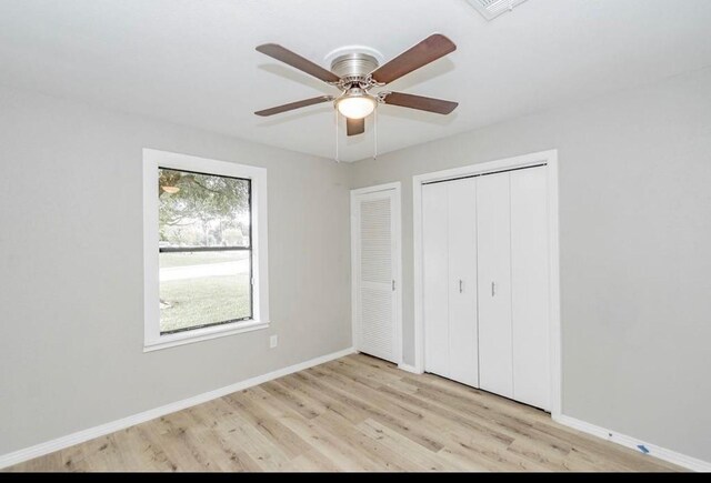 148 Seaside Ln, Texas City, TX 77590 - unfurnished bedroom with light wood-style floors, baseboards, a closet, and ceiling fan