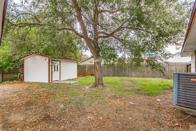 148 Seaside Ln, Texas City, TX 77590 - fenced backyard with central air condition unit, an outdoor structure, and a storage shed