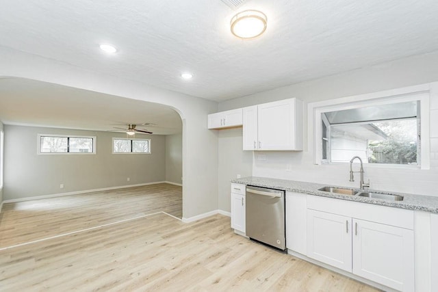 148 Seaside Ln, Texas City, TX 77590 - kitchen with a sink, dishwasher, light stone counters, ceiling fan, and arched walkways