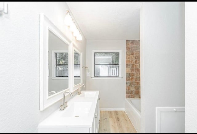148 Seaside Ln, Texas City, TX 77590 - bathroom with wood finished floors and double vanity