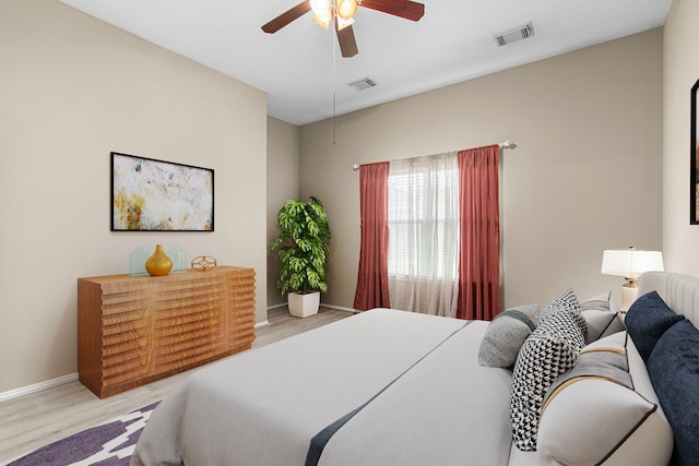 bedroom featuring wood finished floors, baseboards, and a ceiling fan