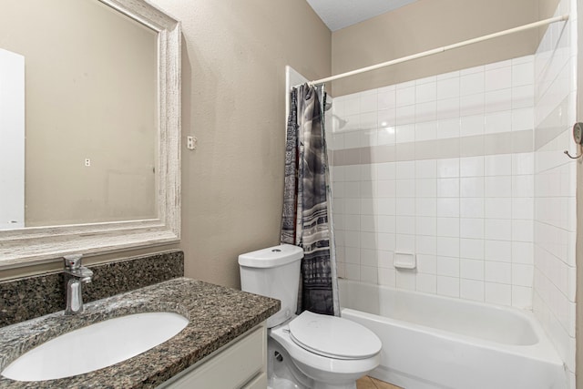 bathroom with vanity, shower / bath combo, toilet, and a textured wall