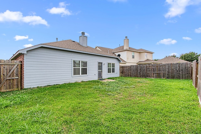 back of property with a shingled roof