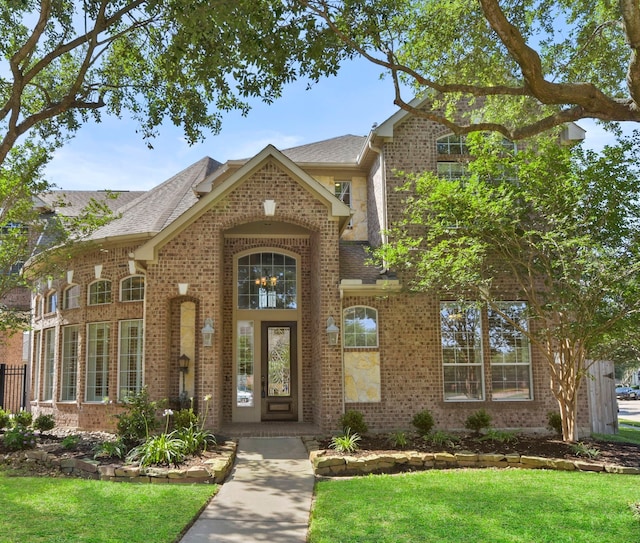 8611 Springmere Ct, Houston, TX 77095 - property entrance with brick siding, a yard, and a shingled roof