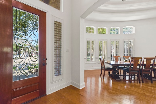 8611 Springmere Ct, Houston, TX 77095 - entryway featuring wood finished floors, arched walkways, baseboards, and a tray ceiling