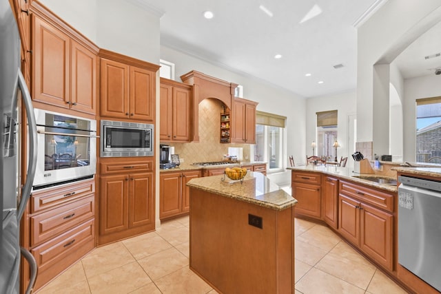 8611 Springmere Ct, Houston, TX 77095 - kitchen featuring appliances with stainless steel finishes, light stone countertops, decorative backsplash, light tile patterned floors, and recessed lighting