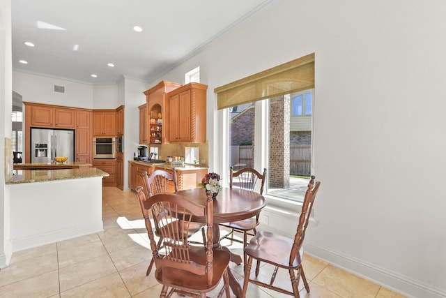 8611 Springmere Ct, Houston, TX 77095 - dining area with crown molding, light tile patterned floors, recessed lighting, and baseboards