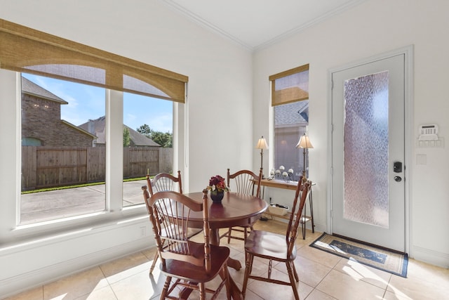 8611 Springmere Ct, Houston, TX 77095 - dining space with healthy amount of natural light, light tile patterned floors, and crown molding