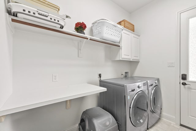 8611 Springmere Ct, Houston, TX 77095 - laundry area with cabinet space, washer and clothes dryer, baseboards, and light tile patterned flooring