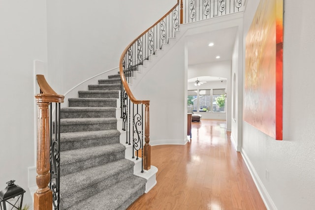 8611 Springmere Ct, Houston, TX 77095 - stairs with wood finished floors, a ceiling fan, baseboards, a high ceiling, and recessed lighting
