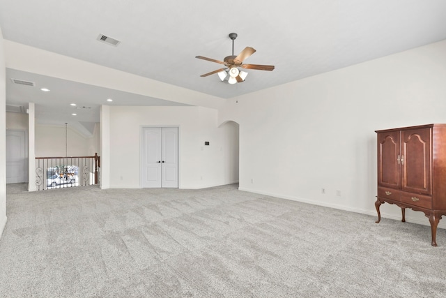 8611 Springmere Ct, Houston, TX 77095 - unfurnished living room featuring ceiling fan, carpet floors, recessed lighting, arched walkways, and baseboards