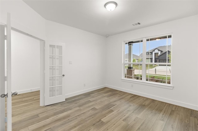 8307 Red Shiner Way, Fulshear, TX 77441 - unfurnished room featuring light wood finished floors, french doors, and baseboards