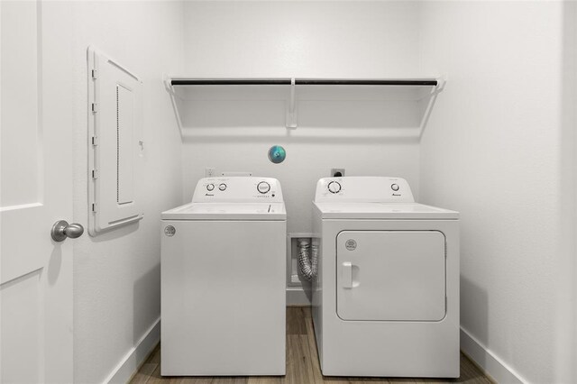 8307 Red Shiner Way, Fulshear, TX 77441 - laundry room featuring washing machine and dryer, wood finished floors, and baseboards